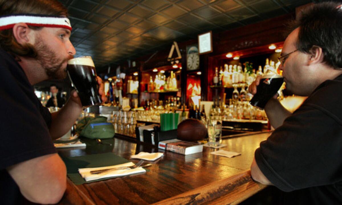 Dan George, left, and Ron Blake enjoy a Guinness at O'Brien's Pub & Restaurant in Santa Monica.