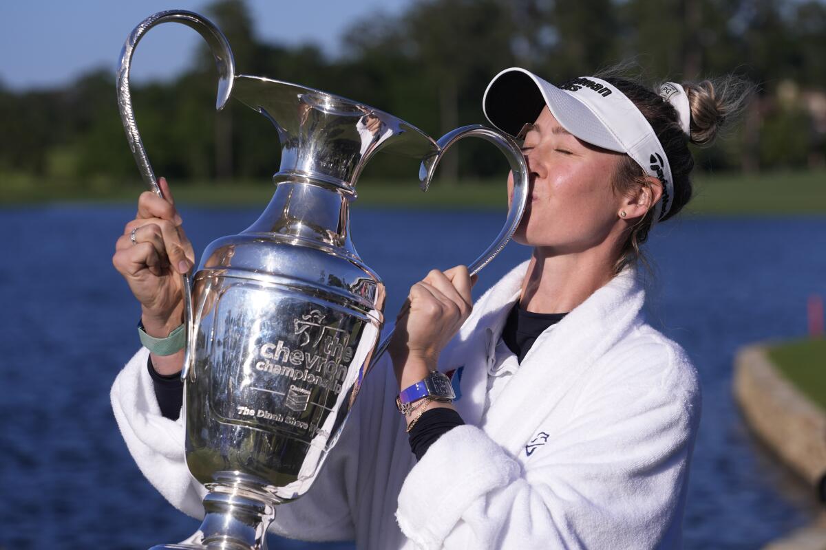 Nelly Korda kisses her trophy after winning the Chevron Championship LPGA golf tournament on April 21.