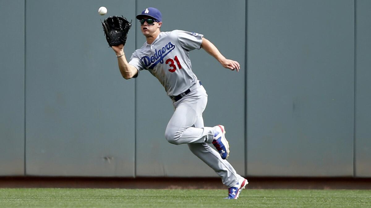 Dodgers center fielder Joc Pederson catches a fly ball on the run during a game against the Reds on Thursday in Cincinnati.