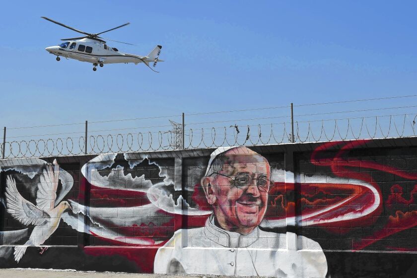 A mural welcomes Pope Francis to Ecatepec, outside Mexico City. The pope arrives in Mexico on Friday.