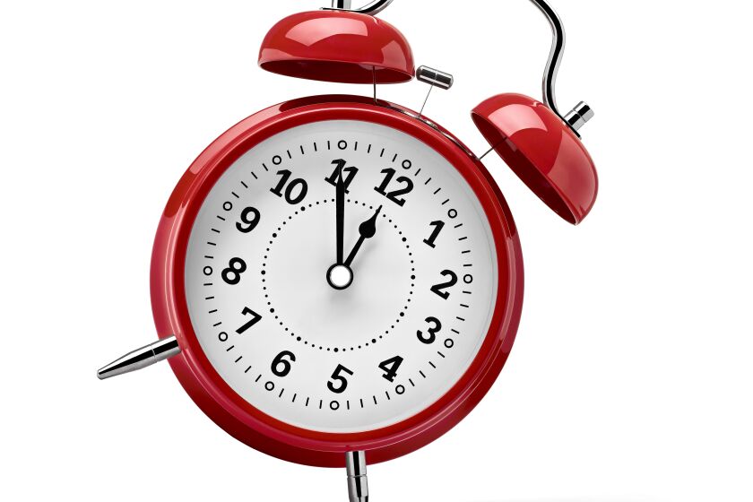close up of a red clock on white background