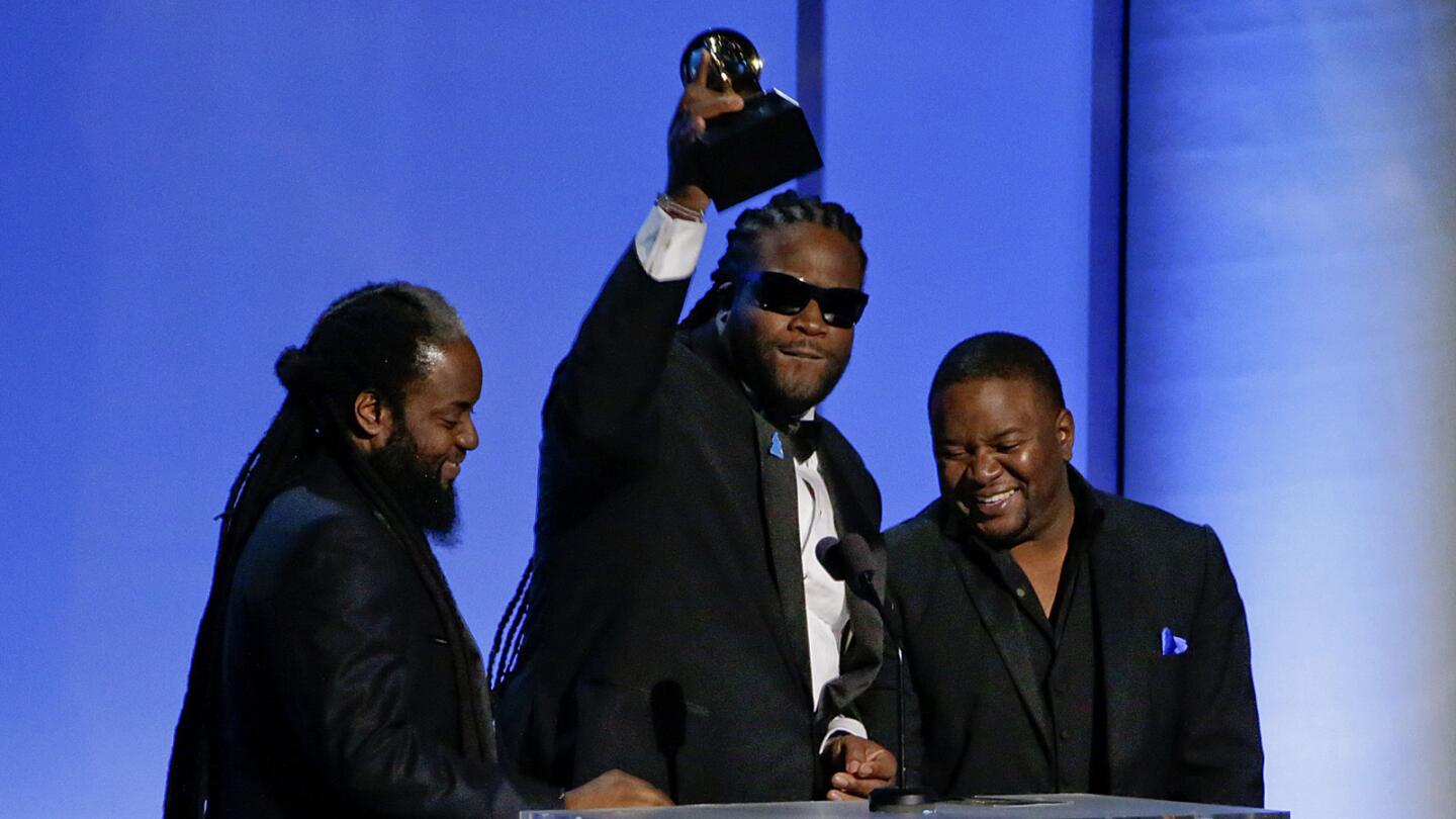 Musicians Peter "Peetah" Morgan, left, Roy "Gramps" Morgan and Nakamyah "Lukes" Morgan of Morgan Heritage accept the award for reggae album for "Strictly Roots" at the pre-telecast show.