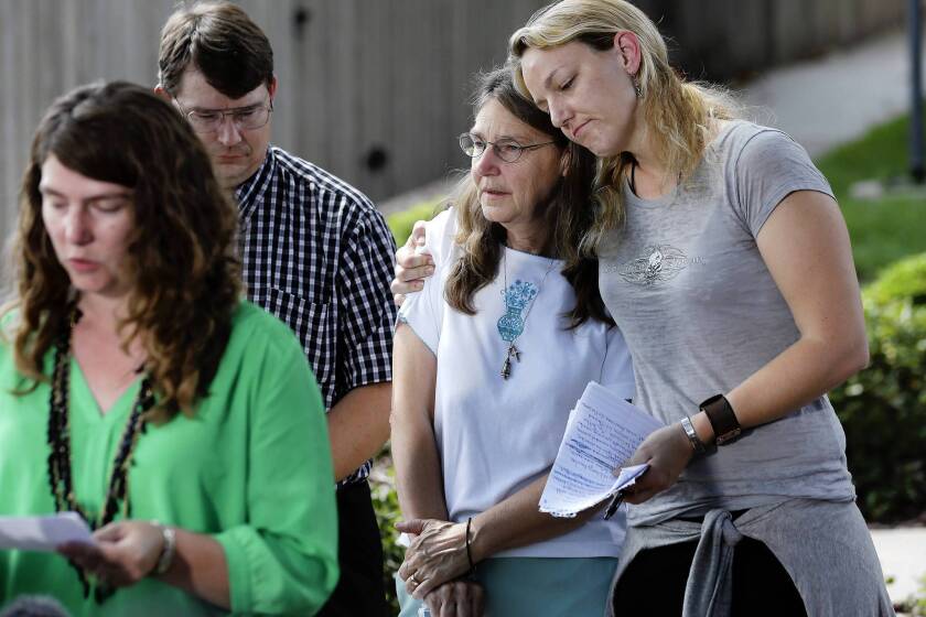 Kerry Cahill, right, comforts her mother, Joleen, as they join other family members to talk about Michael Cahill, who was killed in the 2009 mass shooting at Ft. Hood, Texas. Also pictured are Keely Vanacker and brother James.