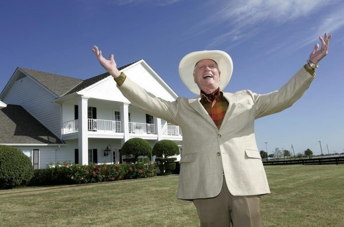 Larry Hagman poses in front of the Southfork Ranch mansion in Parker, Texas, made famous in the television show "Dallas."