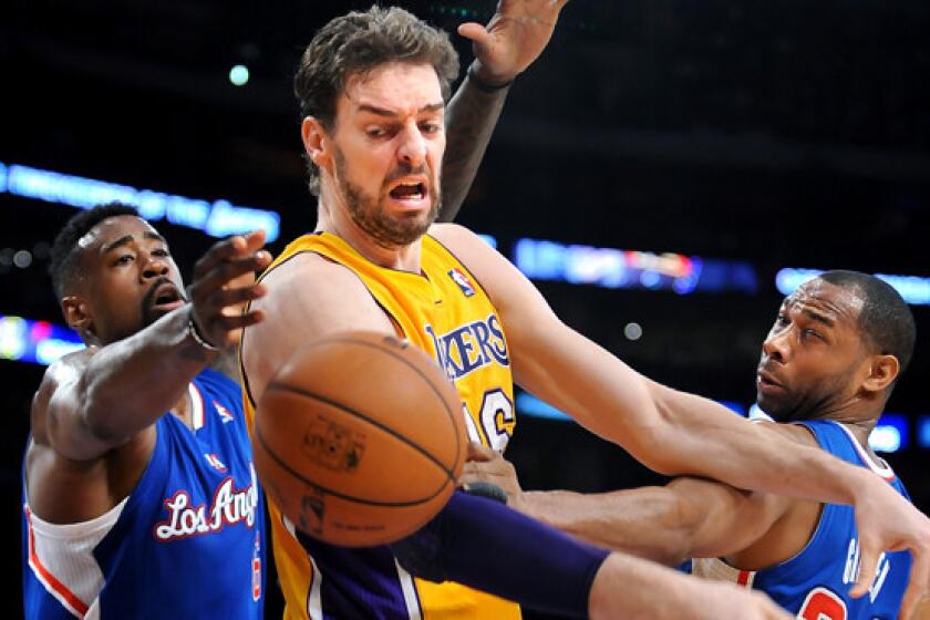 Lakers center Pau Gasol, middle, loses control of the ball in front of Clippers teammates DeAndre Jordan, left, and Willie Green during the Lakers' 142-94 loss March 6. One longtime Lakers fan has grown weary of the team's problems on and off the court.