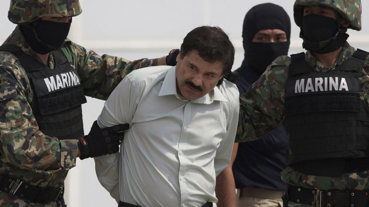 Joaquin "El Chapo" Guzman is escorted by Mexican marines to a helicopter in Mexico City on Feb. 22, 2014.