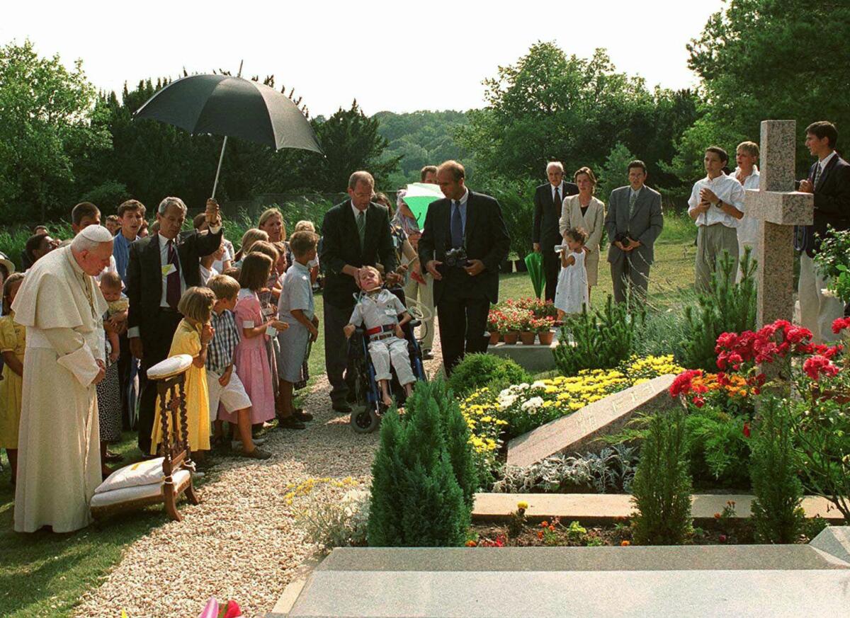 Pope John Paul II by the grave of  geneticist Jerome Lejeune near Paris.
