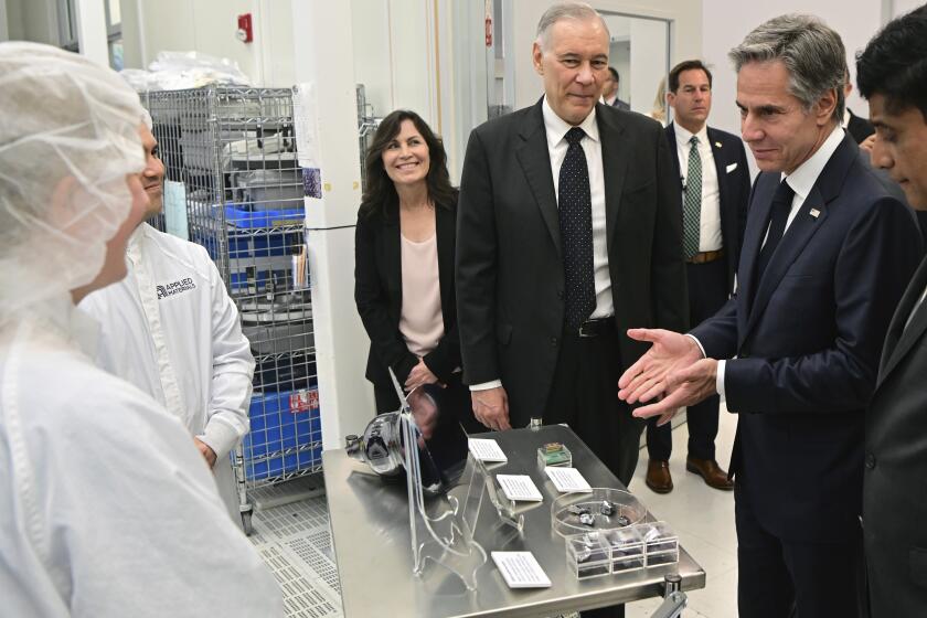 Secretary of State Antony Blinken views products near Applied Materials CEO Gary Dickerson, front row third from right at Applied Materials in Santa Clara, Calif., on Monday, Oct. 17, 2022. (Josh Edelman via AP)