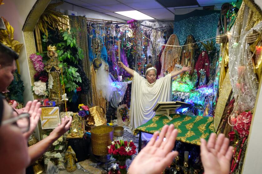 Templo Santa Muerte spiritual leader Sahara Garcia, 54 of Los Angeles, leads a Friday evening service at the temple on the 4900 block of Melrose Ave., on Friday June 30, 2023.