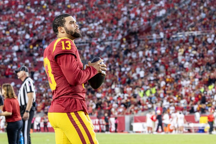 LOS ANGELES, CA - OCTOBER 21, 2023: USC Trojans quarterback Caleb Williams looks up at the score board while staying loose during a timeout in the 34-32 loss to Utah at LA Memorial Coliseum on October 21, 2023 in Los Angeles, California.(Gina Ferazzi / Los Angeles Times)