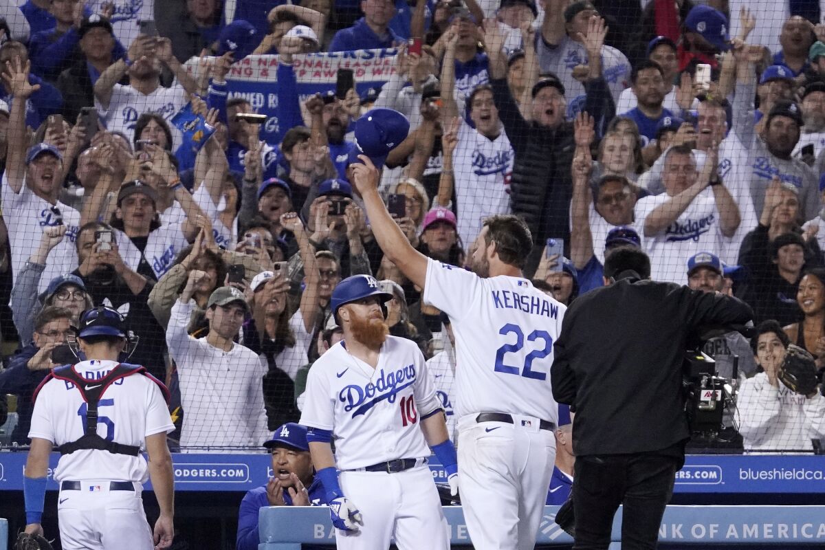 Dodgers pitcher Clayton Kershaw acknowledges a standing ovation from fans.