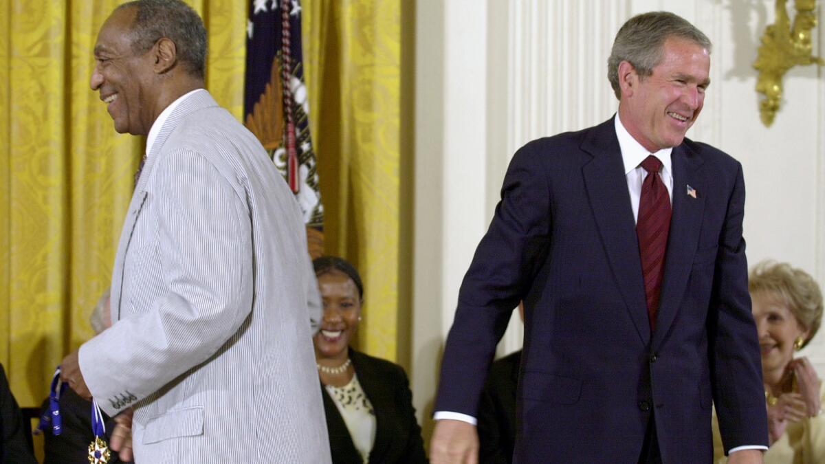 Bill Cosby and former President George W. Bush at the 2002 ceremony where Cosby received the Presidential Medal of Freedom.