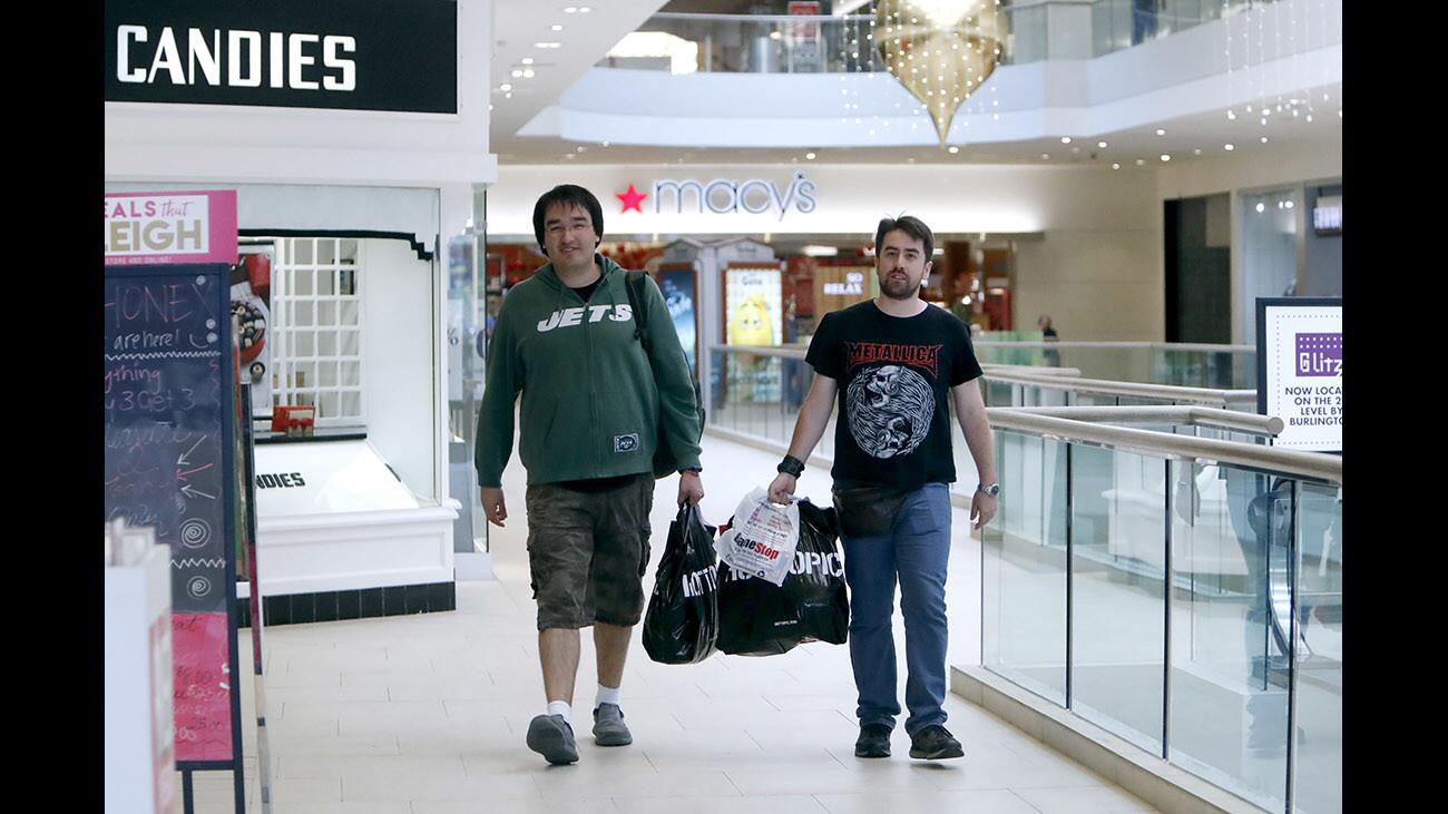 Visiting from Santiago, the capital of Chile, Daniel Cornejo 32, left, and Eduardo MuâˆšÂ±oz 31, shop on Black Friday, at the BurbankTown Center mall in Burbank, on Friday, Nov. 24, 2017.