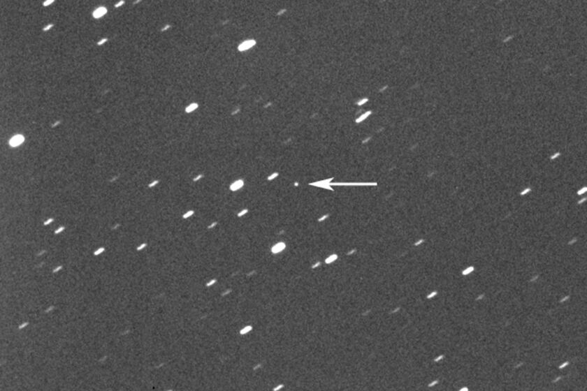 This photo provided by Gianluca Masi shows asteroid 2023 DZ2, indicated by arrow at center, about 1.8 million kilometers (1.1 million miles) away from the Earth on March 22, 2023. On Saturday, March 25, 2023, the asteroid, big enough to wipe out a city, will harmlessly zip between Earth and the moon. While asteroid flybys are common, NASA said it’s rare for one so big to come so close _ about once a decade. Scientists estimate its size somewhere between 140 feet and 310 feet. (42 meters and 94 meters). (Gianluca Masi/Virtual Telescope Project via AP)