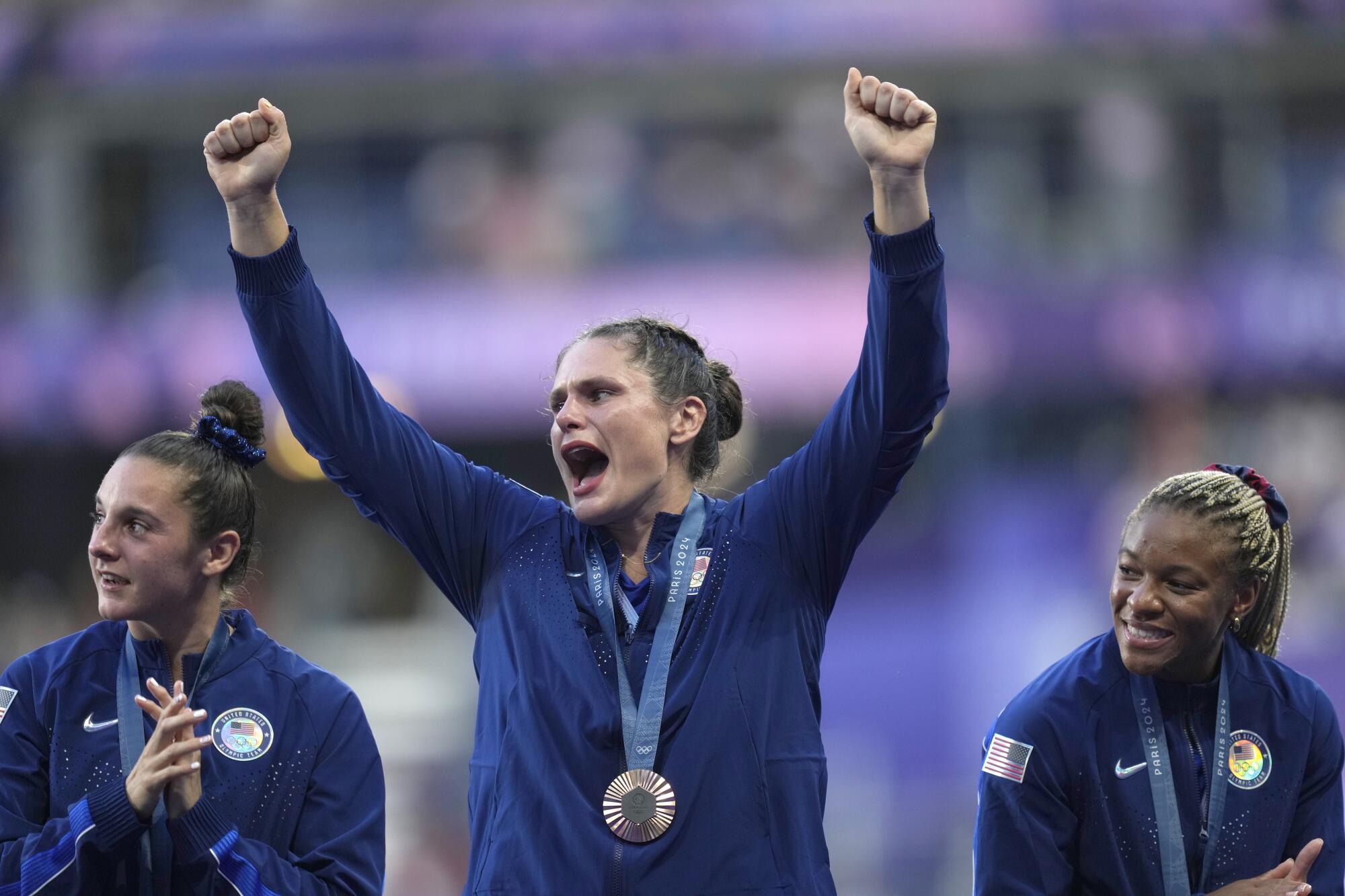 Ilona Maher celebrates on the podium after the U.S. women's rugby sevens team won bronze at the Paris Olympics.