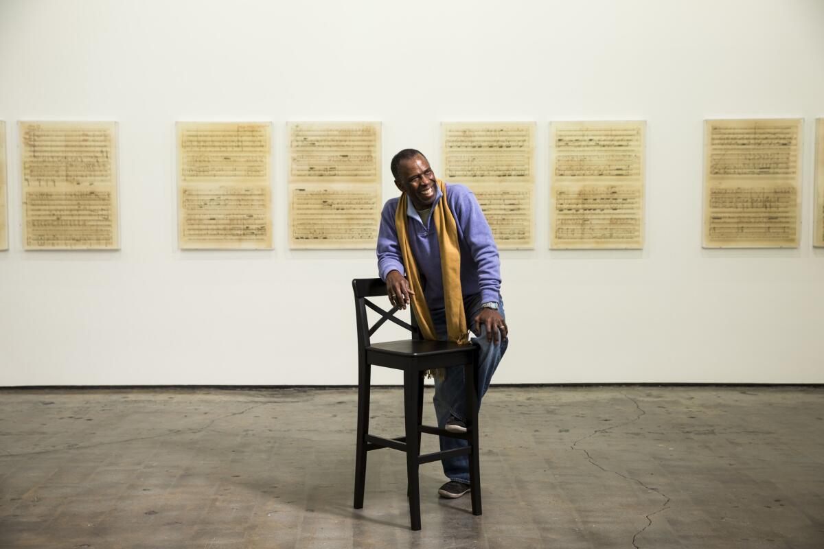 Charles Gaines has a pair of shows in Los Angeles: a solo exhibition of early work at the Hammer Museum and a new installation at Art + Practice in Leimert Park. He is shown here before his piece, "Librettos: Manuel de Falla/ Stokeley Carmichael," at Art + Practice.