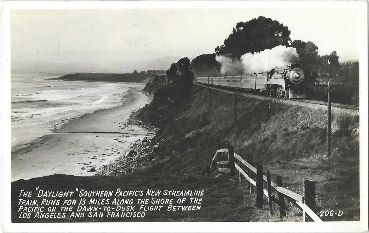Scan of black and white shows Pacific coastline and train tracks atop a small bluff. A locomotive steams along the railway.