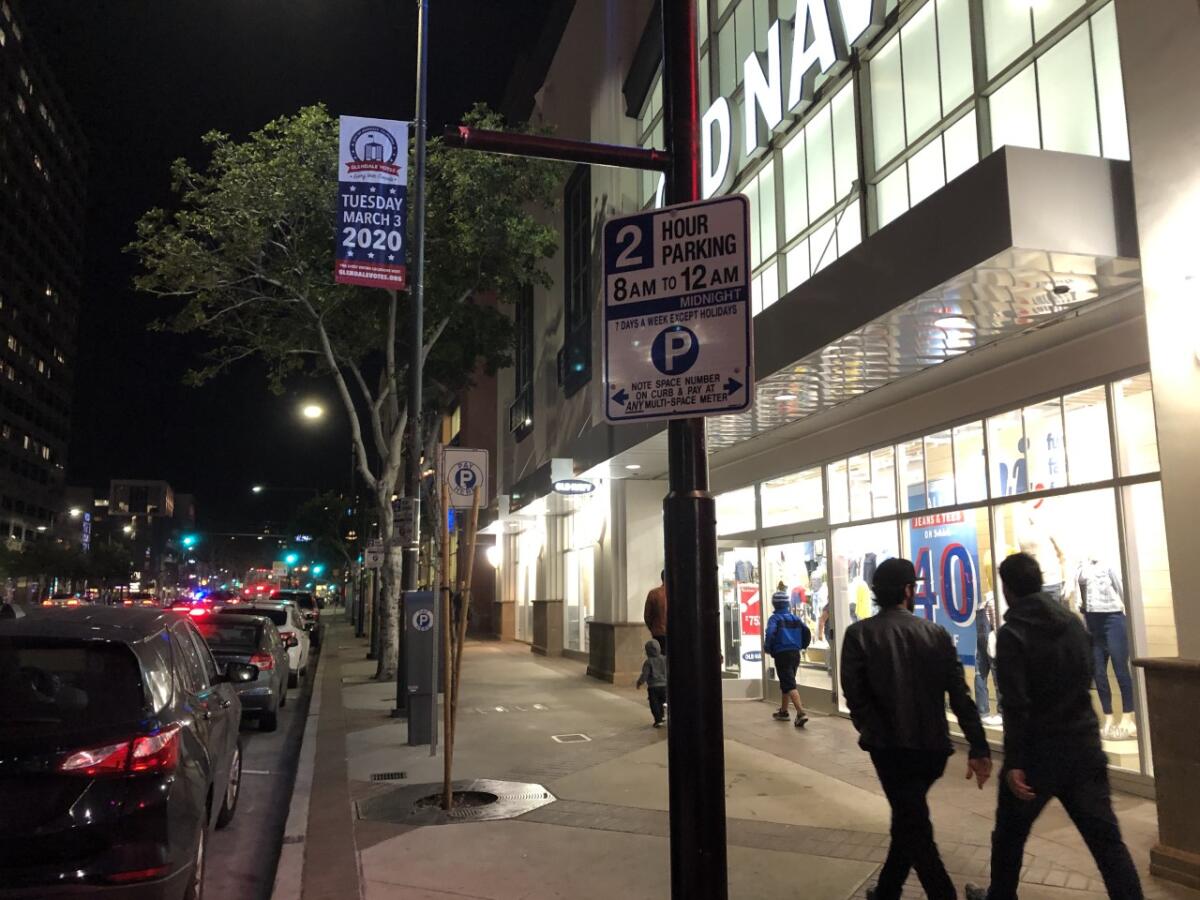 New signs along downtown Glendale's Brand Boulevard reflect that parking-enforcement hours now run until midnight. Currently, the city is issuing warnings for those who fail to feed the meter past 10 p.m., the former cutoff time.