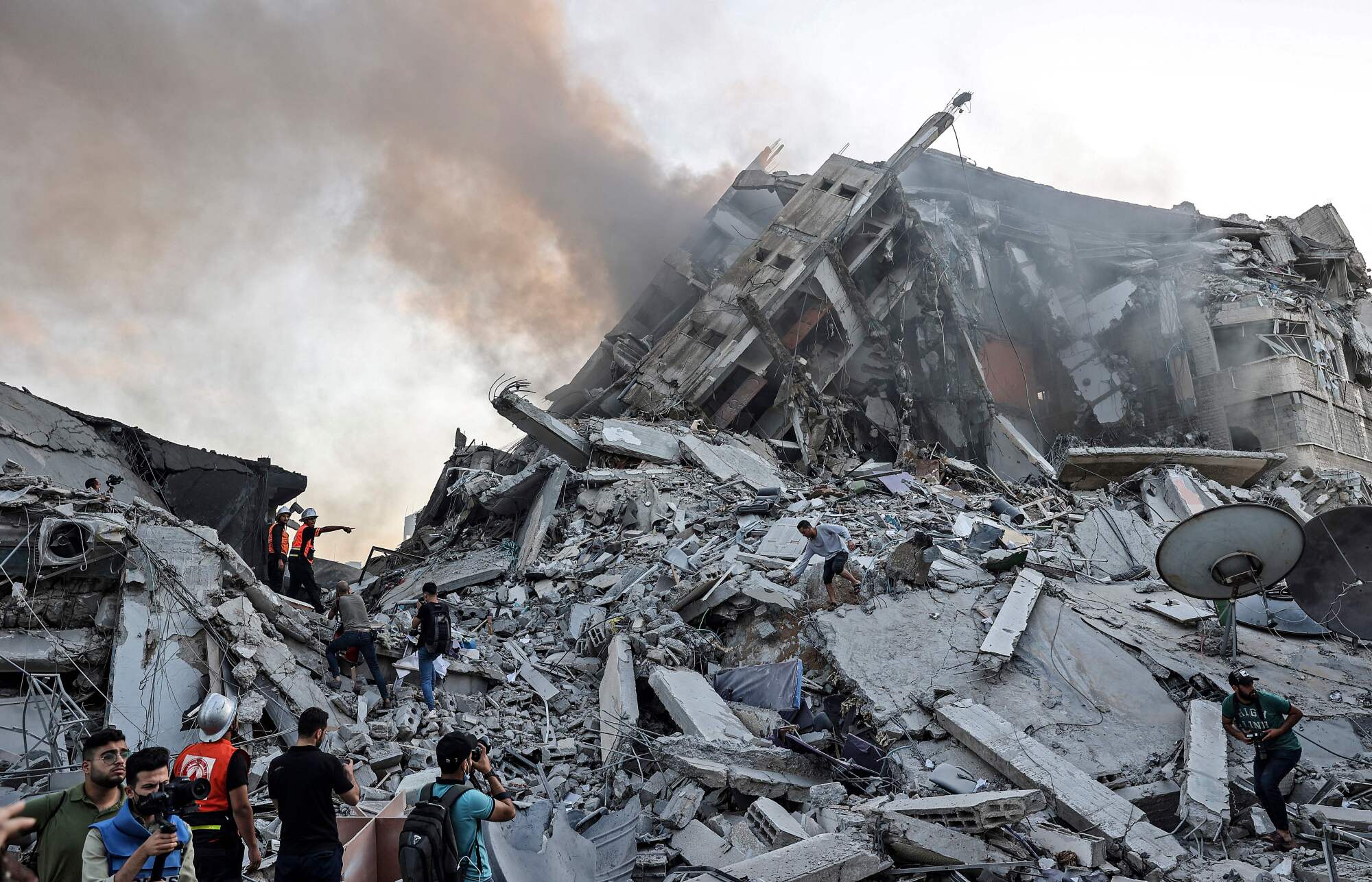 People stand amid rubble. 