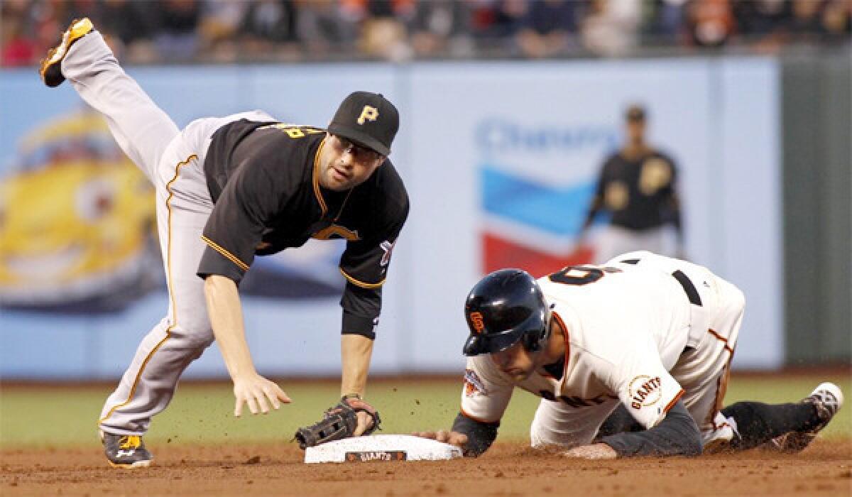 Neil Walker, left, falls as he completes a double play next to Hunter Pence during the second inning of the Pirates' win over the Giants, 10-5, on Thursday.