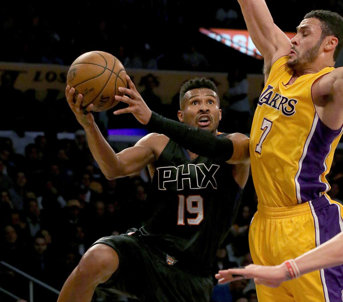 Lakers forward Larry Nance Jr. challenges a shot by Suns guard Leandro Barbosa in the first quarter.