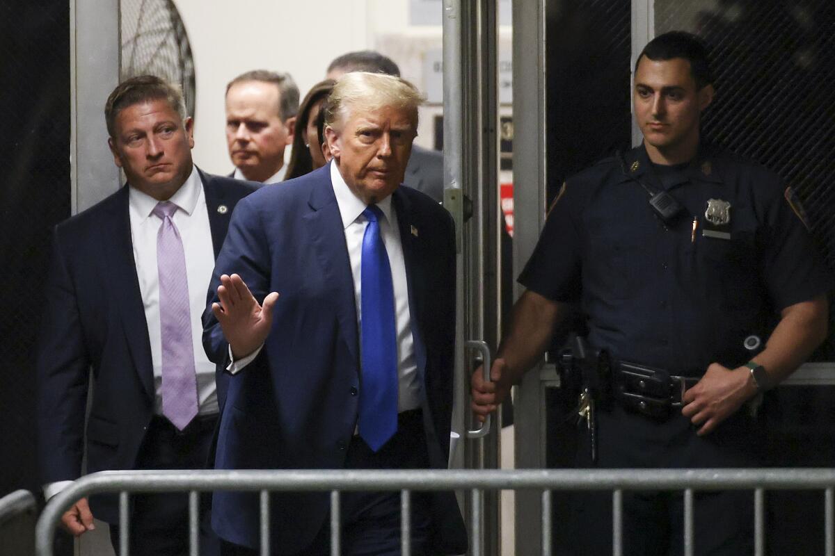 Former President Trump returns to the courtroom after a recess.
