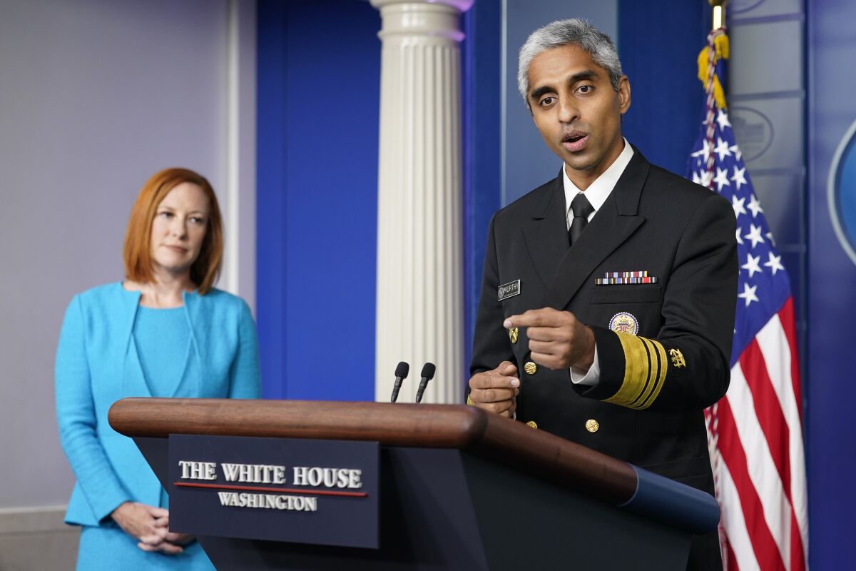 Surgeon General Dr. Vivek Murthy speaks during the daily briefing at the White House in Washington, Thursday, July 15, 2021. White House press secretary Jen Psaki listens at left. (AP Photo/Susan Walsh)