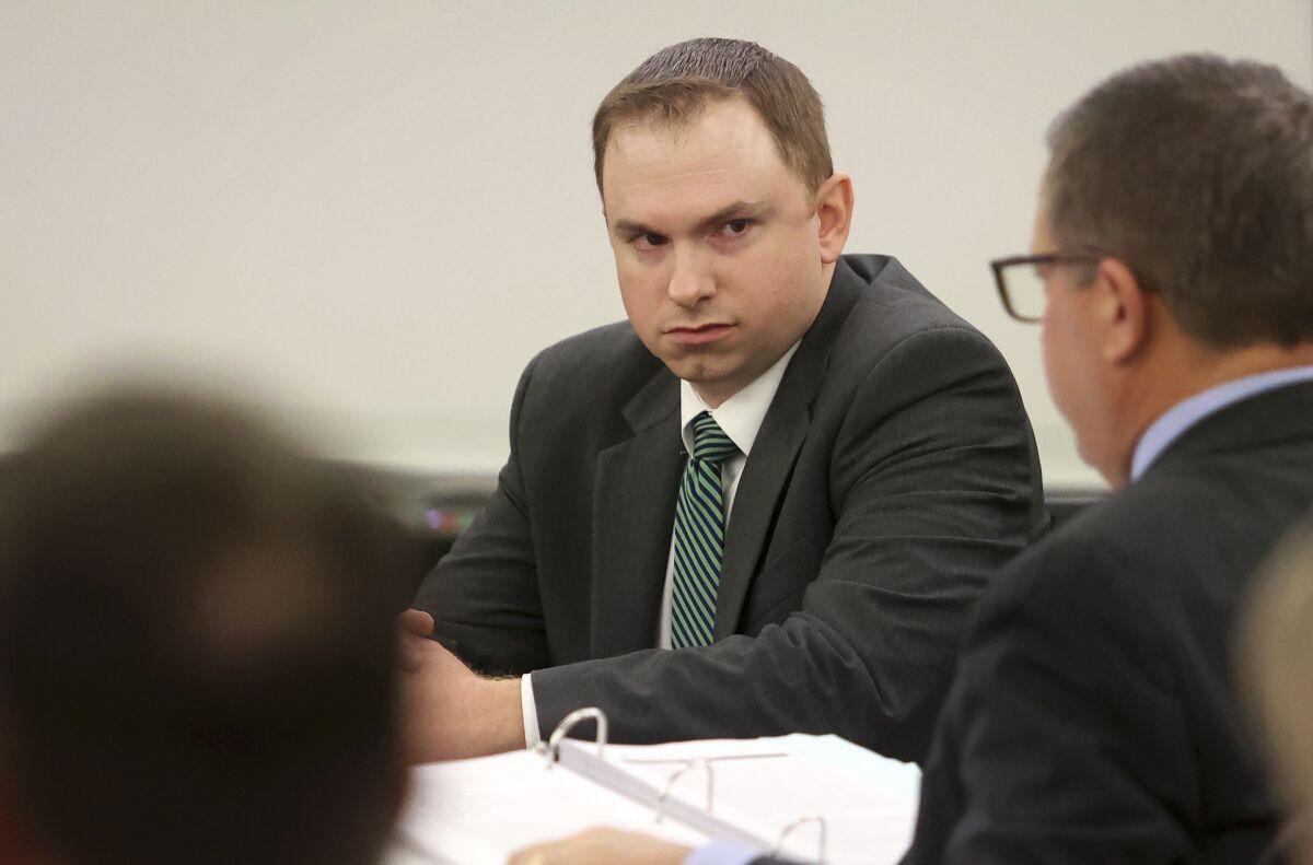 Former Fort Worth Police Officer Aaron Dean looks towards his attorneys during the second day of his murder trial on Tuesday, Dec. 6, 2022, in Fort Worth, Texas. Dean is accused of fatally shooting Atatiana Jefferson in 2019 during a welfare check. (Amanda McCoy/Star-Telegram via AP, Pool)