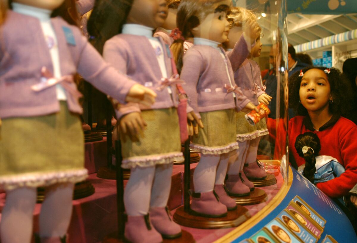 Samantha Small, 7, of Brooklyn, N.Y., looks at dolls for sale at the American Girl Place store in New York on Nov. 8, 2003.