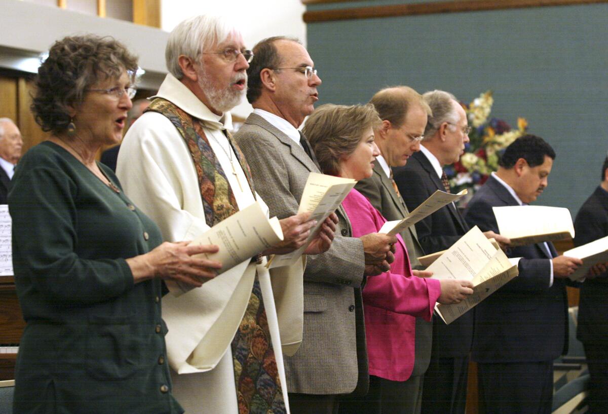 Religious leaders participate in a song at a community Thanksgiving event in 2007.