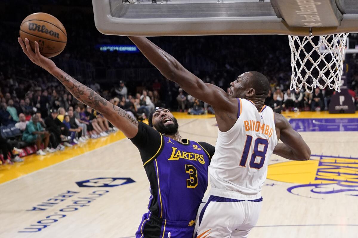 Lakers forward Anthony Davis tries to score inside against Suns center Bismack Biyombo.