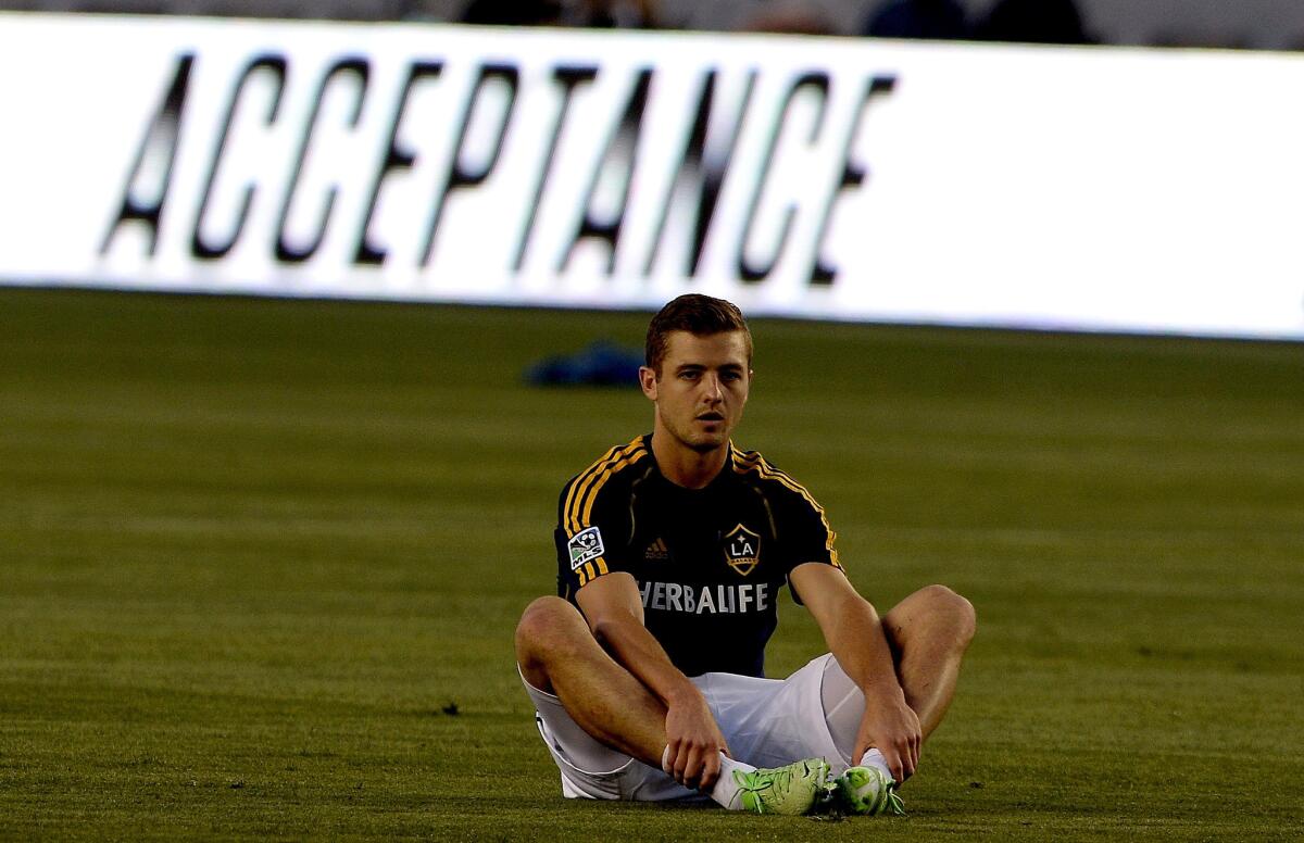 Robbie Rogers stretches as the Galaxy players loosen up before the start of their game against Seattle on Sunday night at Home Depot Center.