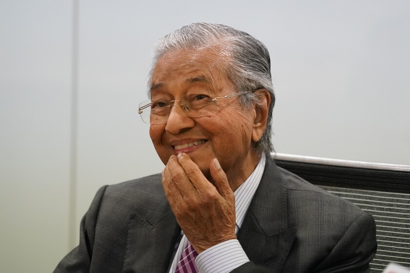 FILE - Malaysia's former Prime Minister Mahathir Mohamad, reacts during a press conference in Kuala Lumpur, Malaysia, on Monday, Dec. 14, 2020. Mahathir, 96, was hospitalized for the third time in just over a month, his spokesperson said Saturday, Jan. 22, 2022, sparking concerns over his health. (AP Photo/Vincent Thian, File)