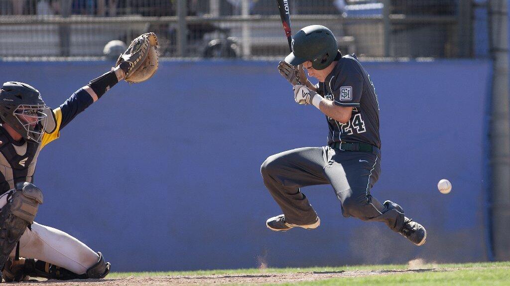 Sage Hill School's Daniel Fishman (24) is hit in the head by a pitch during the fourth inning against Crean Lutheran in the CIF-SS Division 6 baseball championship game at UCR Sports Complex in Riverside on Saturday.