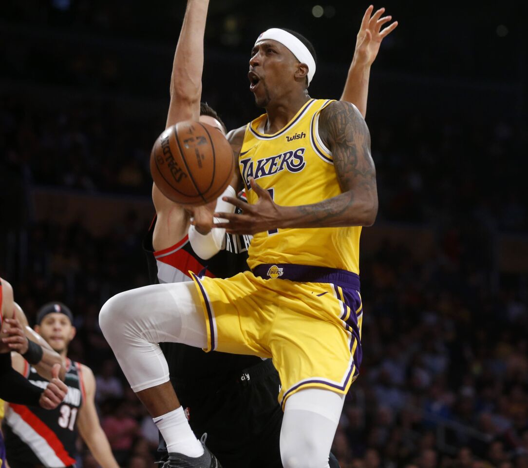 Lakers guard Kentavious Caldwell-Pope loses the ball while driving to the basket.