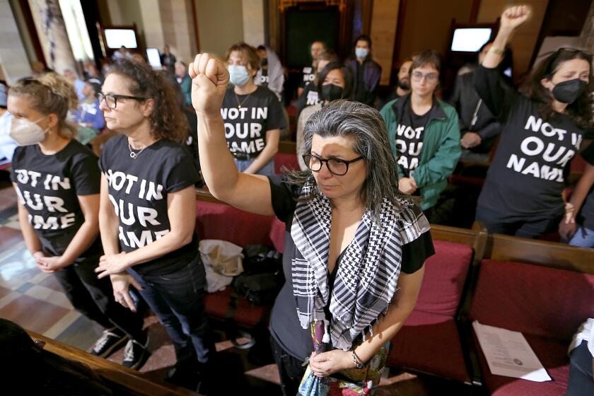 Los Angeles, CA - Los Angeles resident Emily Dibini joins a group of Jewish activists calling on elected officials to support a ceasefire between Israelis and Palestinians at war in Gaza, during a meeting of the Los Angeles City Council in city hall on Tuesday, Nov. 28, 2023. (Luis Sinco / Los Angeles Times)