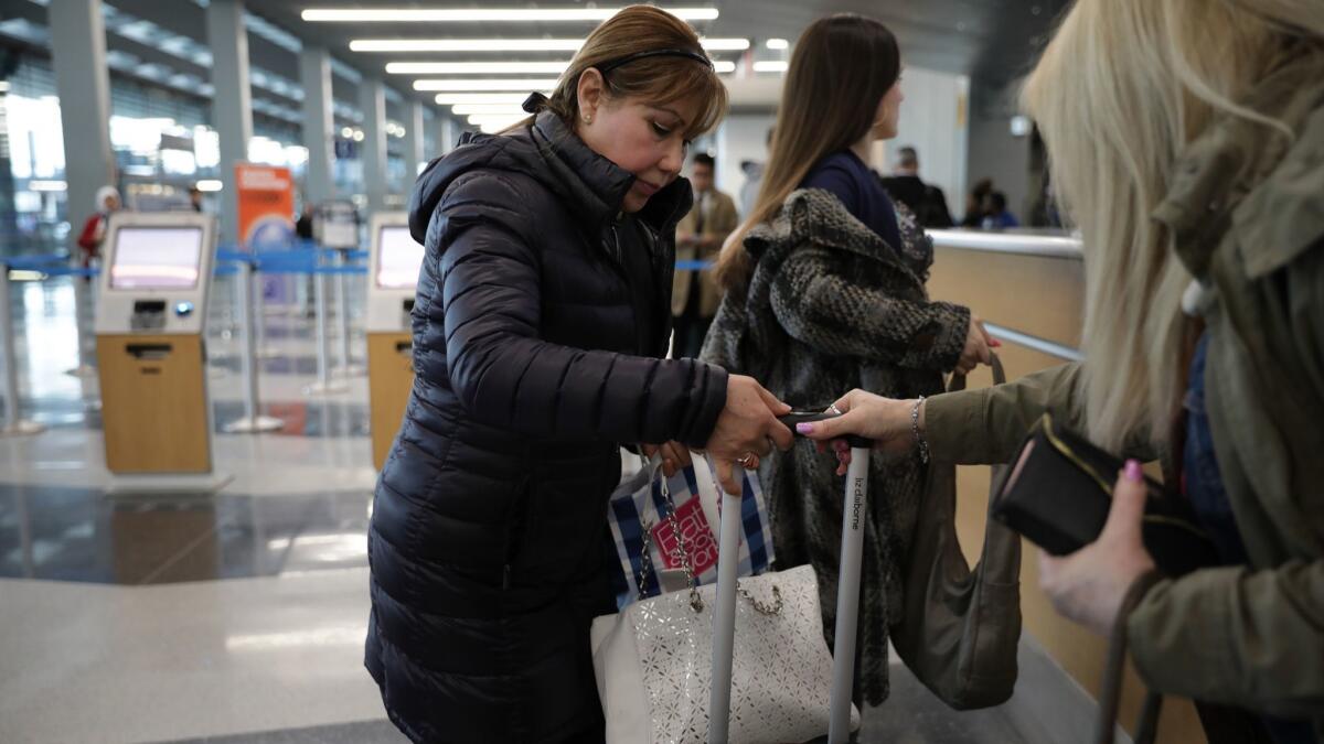 Esperanza Montes Perez prepares to board a flight at Chicago's O'Hare International Airport to visit her son Miguel Perez Jr. in Mexico after he was deported on Sunday,