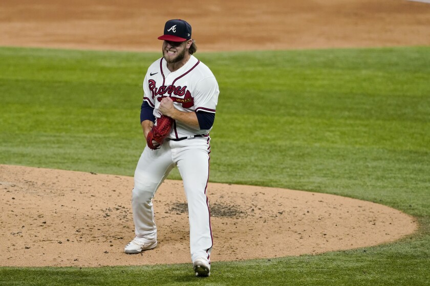Atlanta Braves pitcher A.J. Minter celebrates after striking out the Dodgers' Mookie Betts in the third inning.