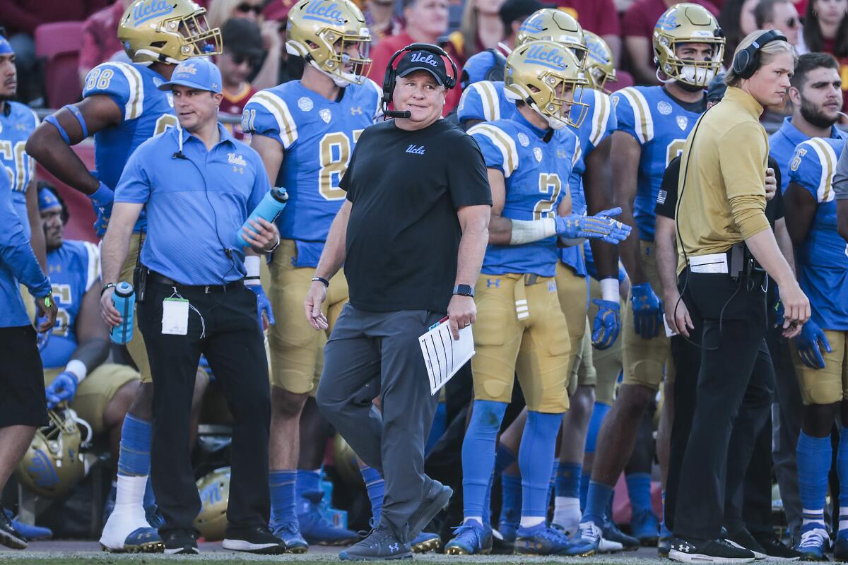 UCLA coach Chip Kelly looks on from the sideline as the Bruins play USC.