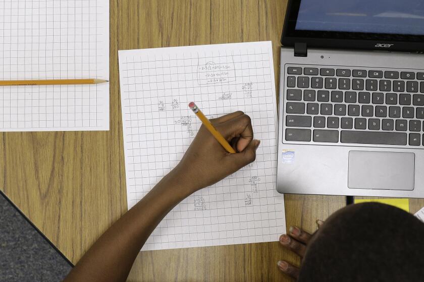 Yamarko Brown, 12, works on math problems as part of a trial run of a new state assessment test at Annapolis Middle School in Md.
