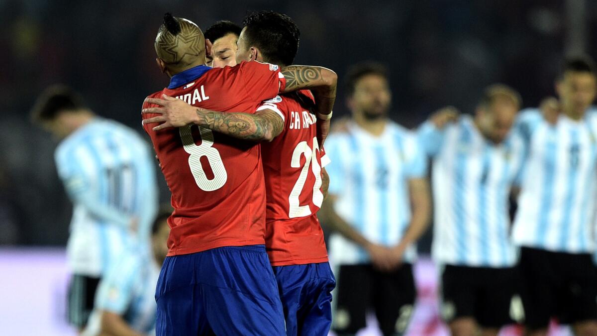 Chile's Arturo Vidal, Charles Aranguiz and Gary Medel celebrate after defeating Argentina in a penalty-kick shootout to win the Copa America title on Saturday in Santiago, Chile.
