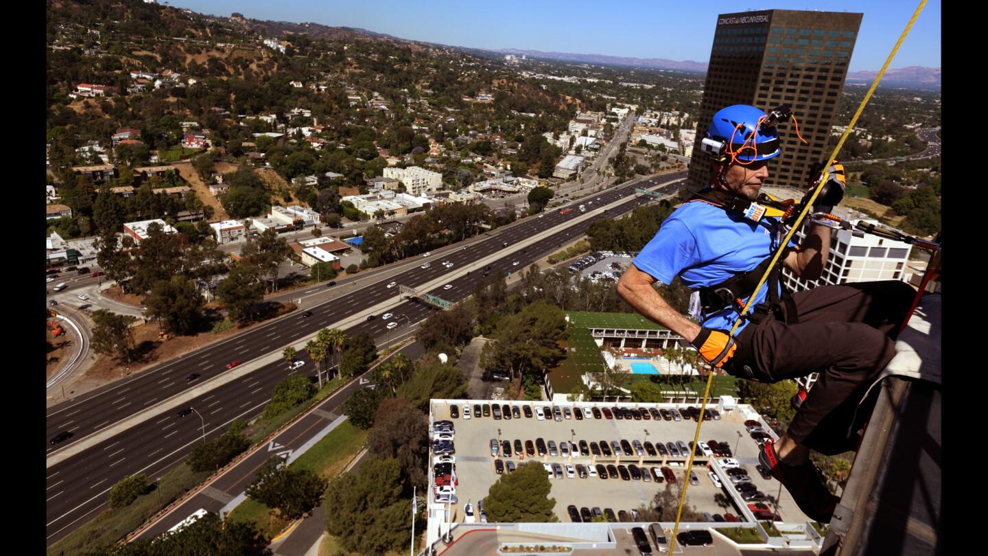 Esophageal cancer survivor Brian Leedom rappels down the Hilton Universal City Hotel as part of "Stories to Save Lives."