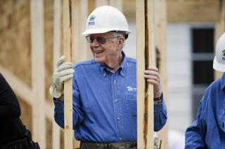 President Carter wearing a hard hat at a building site