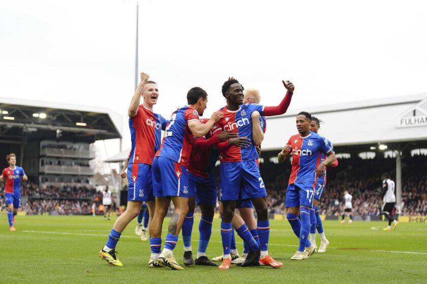 Crystal Palace's team players celebrate after Jeffrey Schlupp scored their side's first goal during the English Premier League soccer match between Fulham and Crystal Palace at Craven Cottage, London, Saturday, April 27, 2024. (Zac Goodwin/PA via AP)