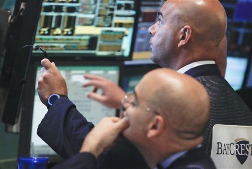 Traders work at the start of early trading at the New York Stock Exchange on Tuesday, July 10, 2012. Stocks are opening higher after European leaders accelerated a plan to shore up Spain's troubled banks. (AP Photo/Bebeto Matthews)