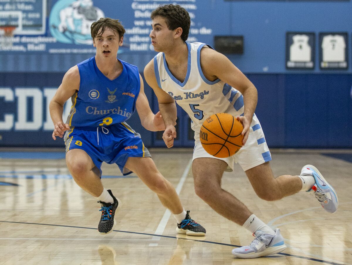 Corona del Mar's Ilan Agranovich drives the lane against a Churchie defender during the CdM Beach Bash on Wednesday.