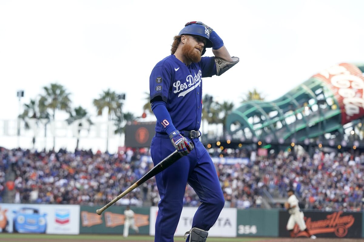 Dodgers third baseman Justin Turner walks to the dugout after striking out.