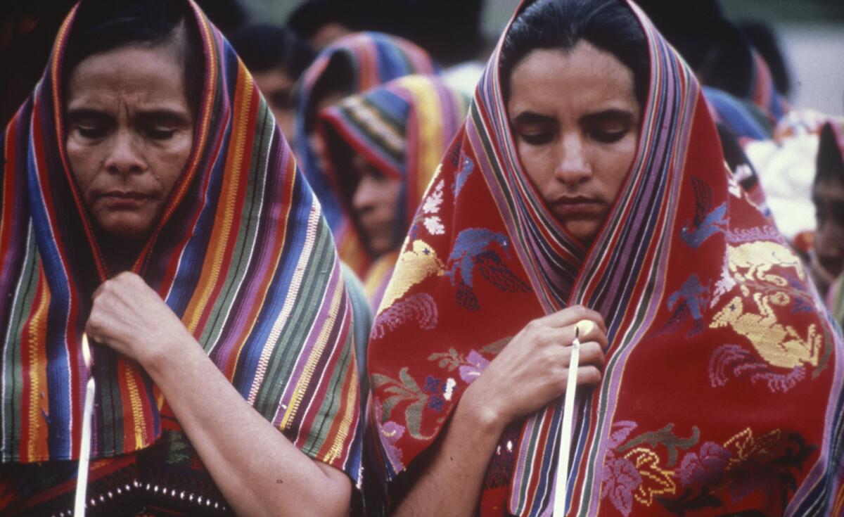 Women stand in shawls.