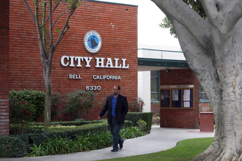 A man walks in front of Bell City Hall. A new audit from the state controller's office showed the city is "facing significant fiscal challenges" that could lead to a "fiscal crisis."