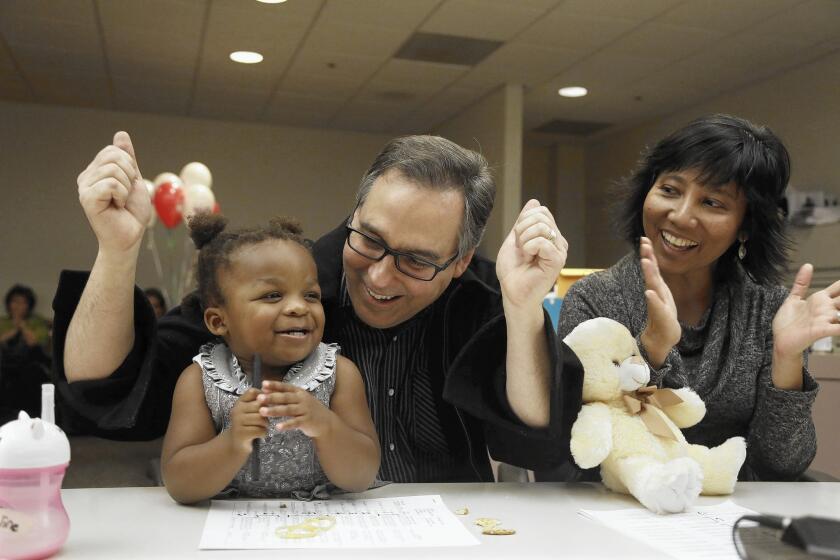 Darrin and Vicky Geary celebrate their adoption of Hannah May, 23 months.